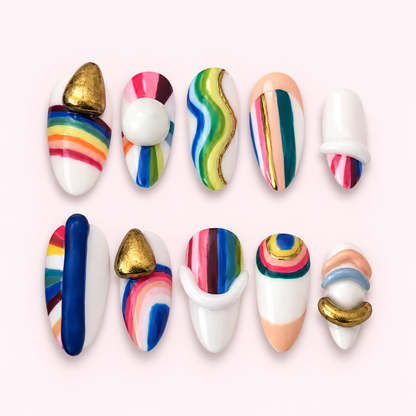 Galleria rainbow sculptural press-on nails on a pale pink background