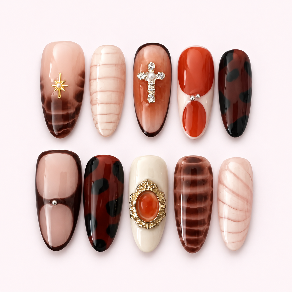 St. Agnes jeweled tortoiseshell press-on nails on a pale pink background
